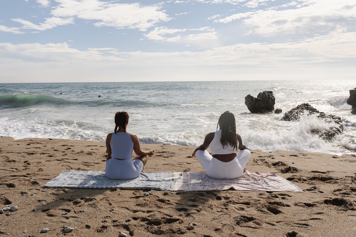 Women Meditating at the Beach